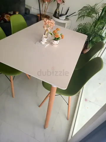 IKEA-style white dining table with 4 green chairs - good condition