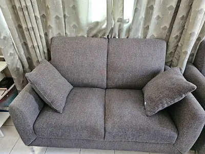 Two-seater grey fabric sofa in good condition