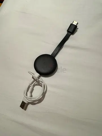 Google Chromecast (2nd/3rd gen) HDMI streaming dongle with USB cable.