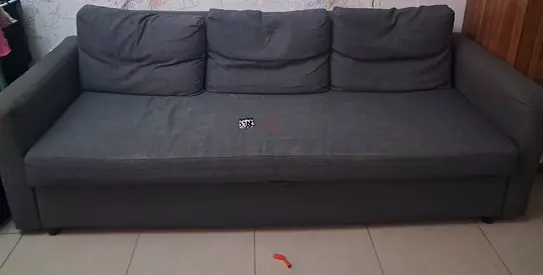 Grey storage sofa bed with under-seat compartments