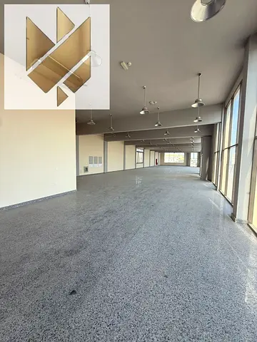 Showrooms, shops, and a yard available for rent in Industrial Area 5, Sharjah, with a total area of 20,000 sq. ft., located on a main road.