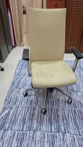 Beige Leather Office Chair with Armrests and Wheels