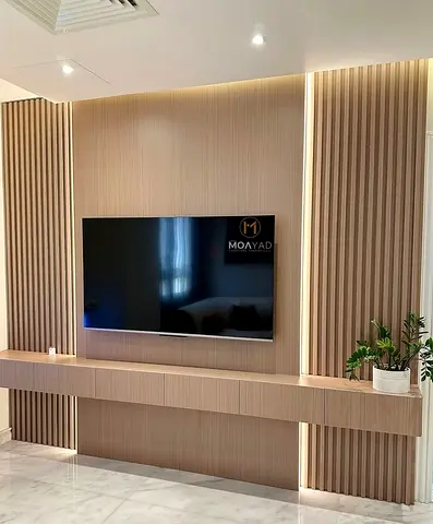 Modern wall-mounted entertainment unit with TV panel and floating console