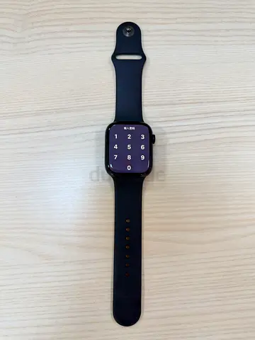 Black Apple Watch Series 7, 45mm, with black case and matching black band. Sleek design, fully funct