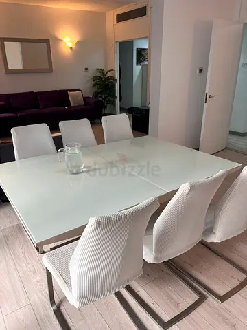 Glass Top Dining Table with 6 Upholstered Chairs + extension + 2 people in the middle of the table