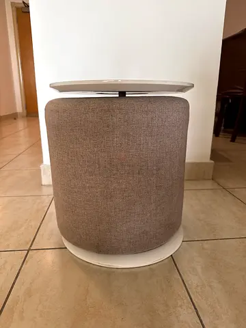 Small round upholstered ottoman/stool in neutral beige