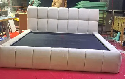King-sized upholstered platform bed with padded headboard and footboard