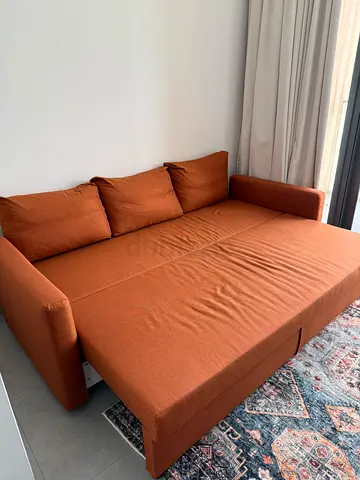 Three-seater convertible sofa bed in terracotta fabric