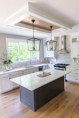 Modern kitchen island with pendant lights — white quartz countertop