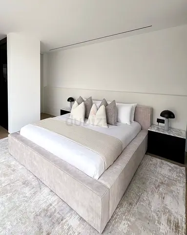 King-sized upholstered bed frame with storage-style base in light grey