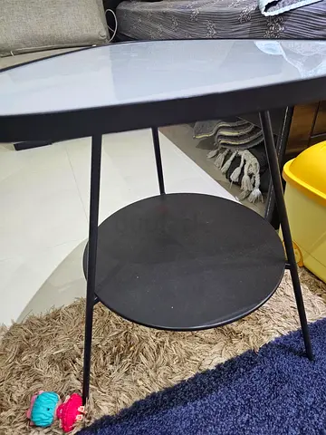 Small black round side table with lower shelf
