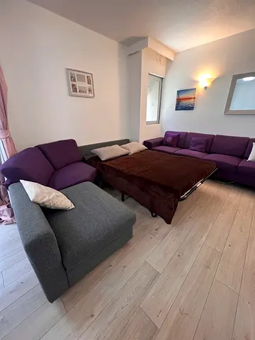 L-shaped purple and grey sectional sofa in good condition