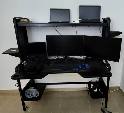 Black gaming/office computer desk with top shelf and side trays - good condition