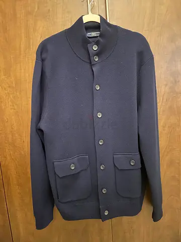 Charles Tyrwhitt merino wool funnel neck blazer featuring patch pockets and a button-front closure.