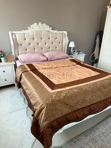 Queen size white upholstered bed with 2 bedside tables, and Wardrobe