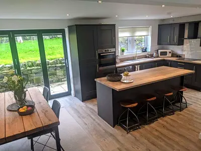 Modern grey kitchen island with breakfast bar and matching cabinetry