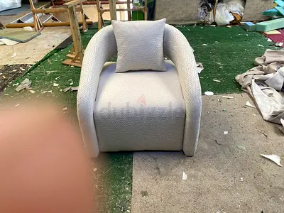 Light grey upholstered single armchair with cushion - good condition