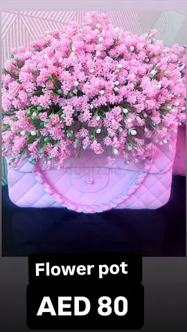 Pink artificial flower arrangement in decorative pot - AED 80