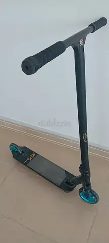 Used stunt/park scooter with teal wheels — good condition