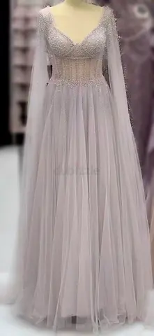 Brand new elegant dress, never worn. High quality fabric with beautiful glitter details and long sle
