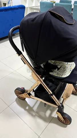 Lightweight gold-frame baby stroller with canopy - good condition