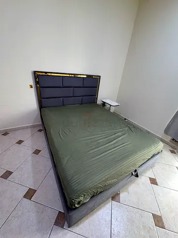 2 Grey upholstered queen bed frame with padded headboard