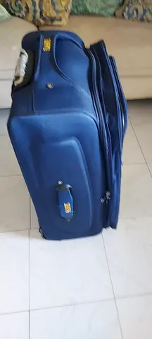 Blue soft-shell roller luggage - medium size, good condition