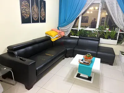 Black L-shaped leather sofa