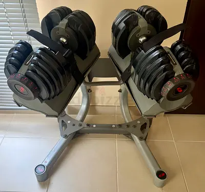 Pair of Bowflex SelectTech Adjustable Dumbbells (Up to 52.5 Ibs / 24 kg) with stand and wheels