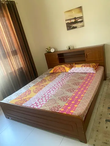 Wooden double bed with built-in headboard storage - good condition