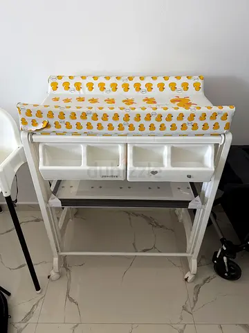 Baby changing table with storage bins and padded mat