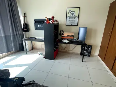 L-shaped double desk setup with central shelving divider (good condition)