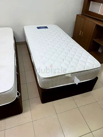 Two single beds with mattresses