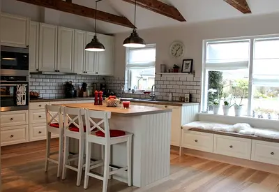 White Shaker Kitchen Island with Built-in Seating and Cabinets