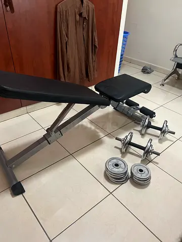 Adjustable weight bench with dumbbells and weight plates - good condition