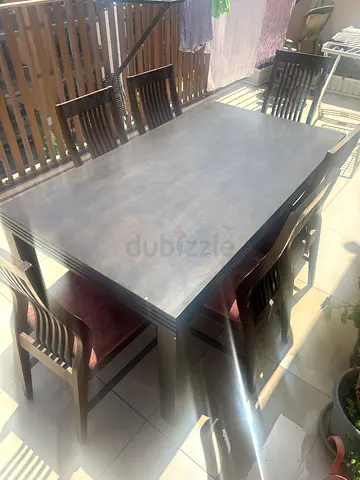 Wooden dining table with 6 matching chairs - good condition. Giving it up for free.