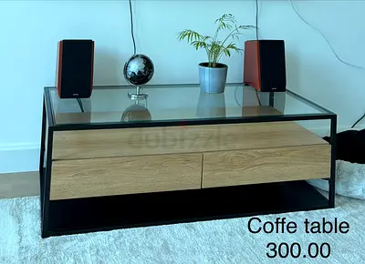 Modern glass-top coffee table with wood drawers