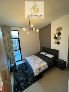 Furnished apartment with a master bedroom, living room, balcony, and two bathrooms, near Dubai exit,