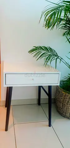 Simple white bedside table with drawer and black legs