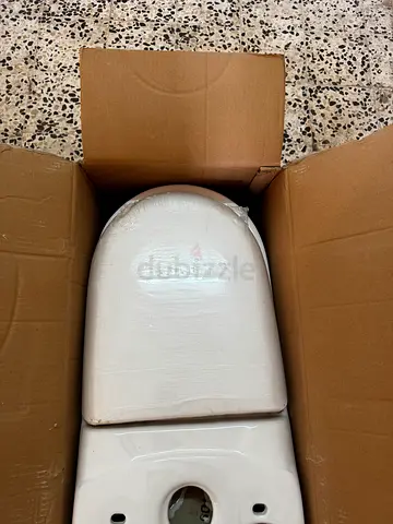 New white ceramic toilet bowl with seat and flush tank (unused, boxed)