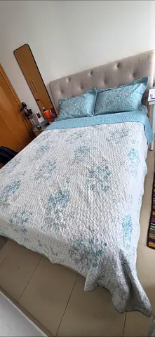 Queen bed with upholstered headboard and bedding set