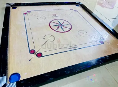 wooden carrom board and coins in good playable condition