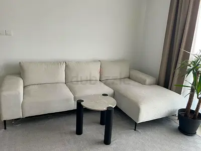 Light beige L-shaped fabric sofa with chaise