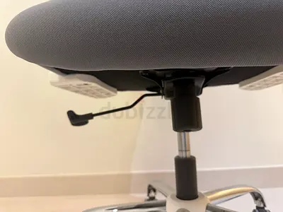 Grey ergonomic office chair with gas lift and tilt lever