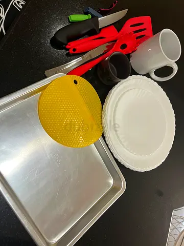 Mixed kitchenware set — baking tray, utensils, plates and mugs
