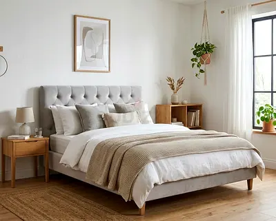 Light grey upholstered double bed with tufted headboard