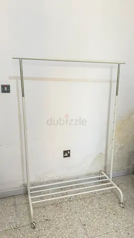 White rolling clothes rack / garment rail with lower shelf