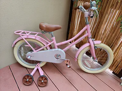 Pink kids bicycle with training wheels — 14-inch