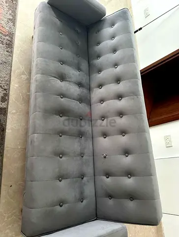 Grey tufted 3-seater sofa bed in good condition