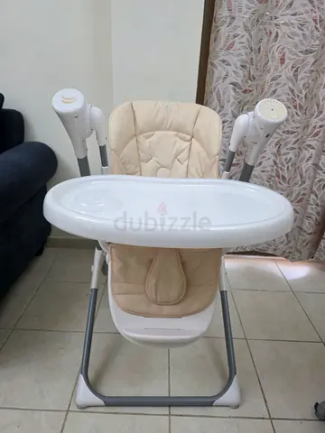 Beige baby high chair with tray - gently used